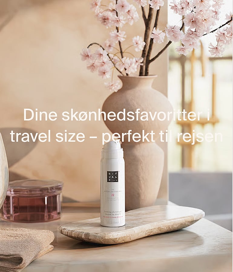 White Rituals brusegel-flaske på marmor, med kirsebærblomster. Rejsestørrelse skønhedsfavoritter, perfekt til rejser.