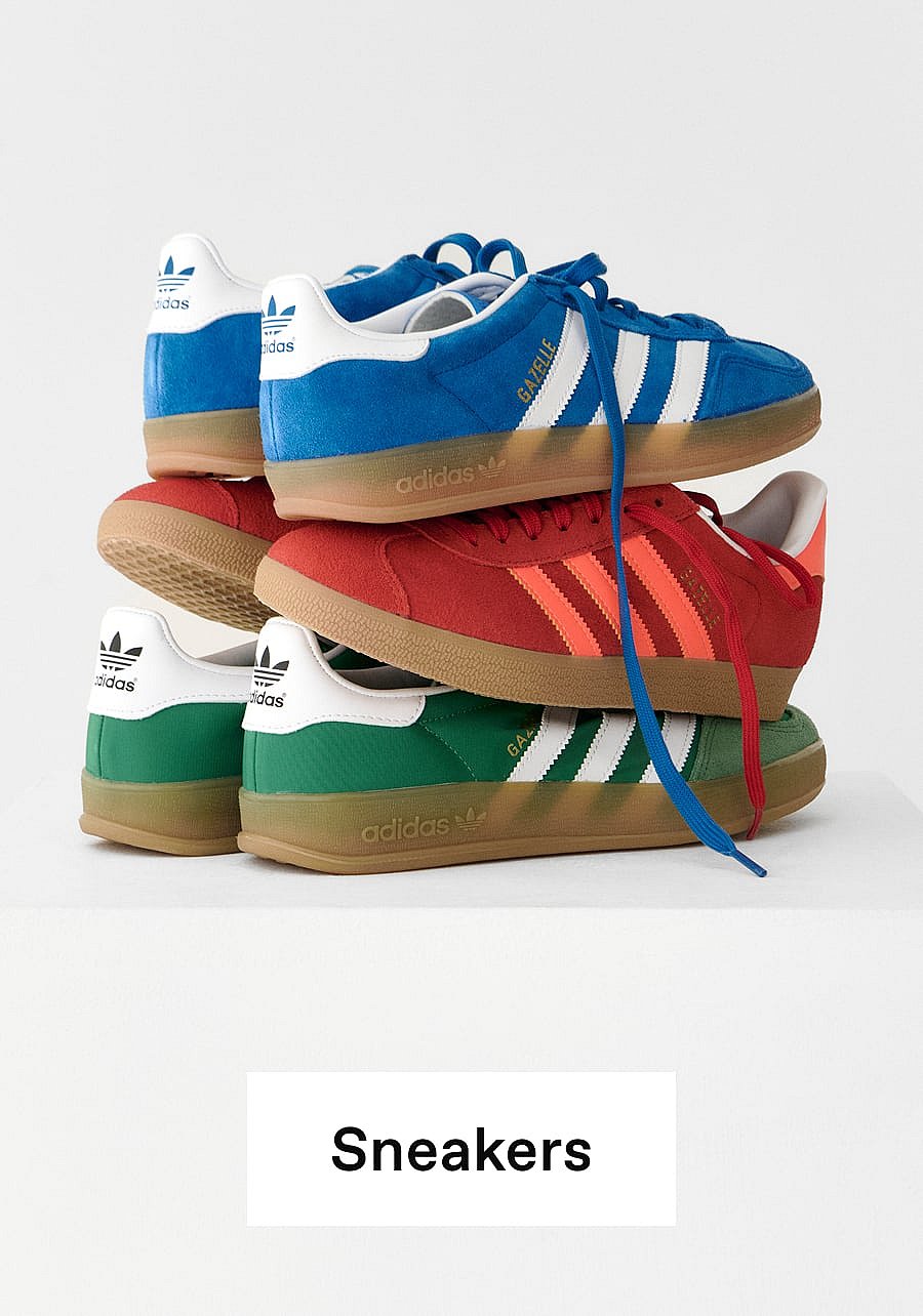 Stacked blue, red, and green Adidas Gazelle sneakers with gum soles on a white background.