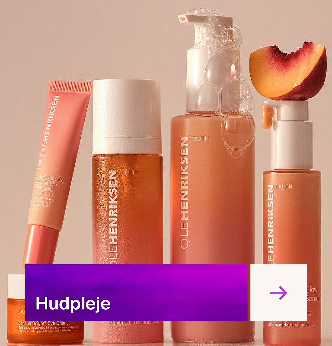 Ole Henriksen ferskenfarvede hudplejeprodukter: flasker, tube og krukke, med en ferskenskive og bobler. Lilla banner
