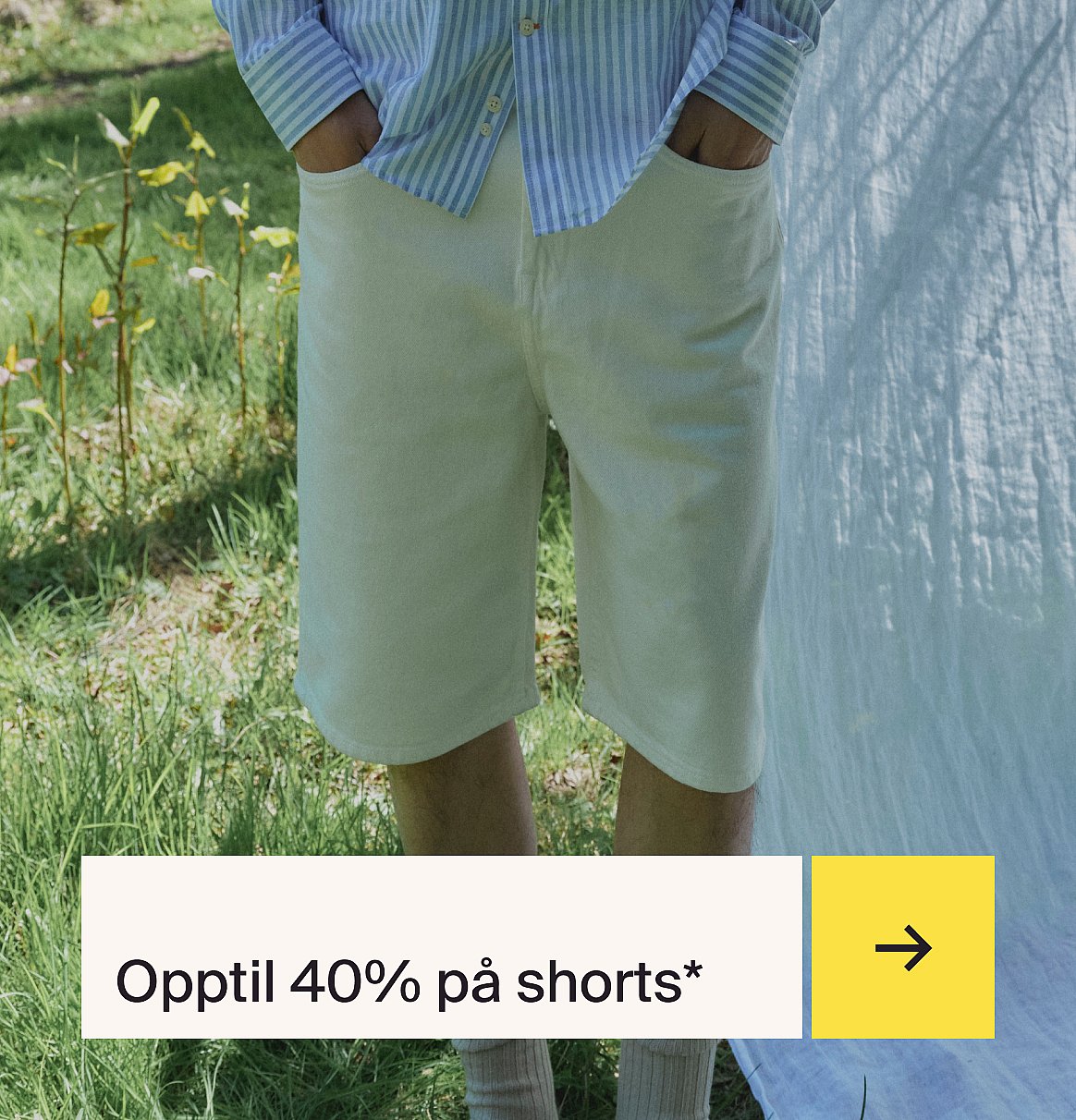 Person i stripete skjorte og lyse shorts står i gresset med hvitt stoff.
Opptil 40% rabatt på shorts.