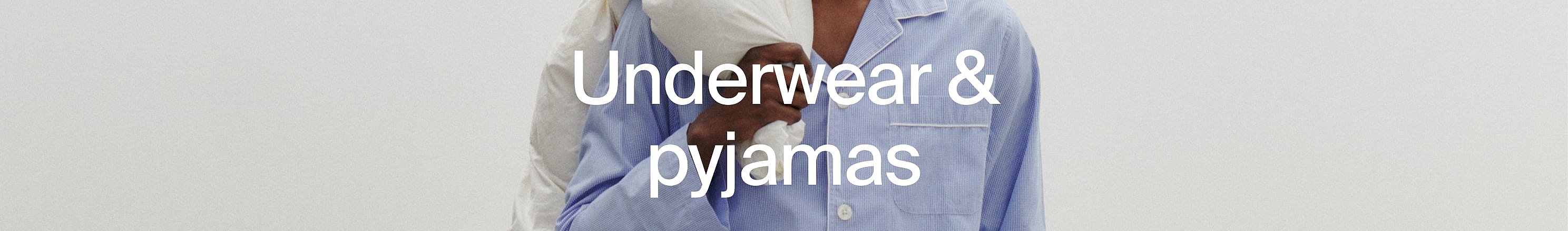 Close-up of two people in pajamas, one white, one blue striped.