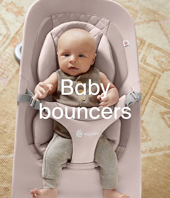 Infant in a pink bouncer on a patterned rug. Text overlay: Baby bouncers.