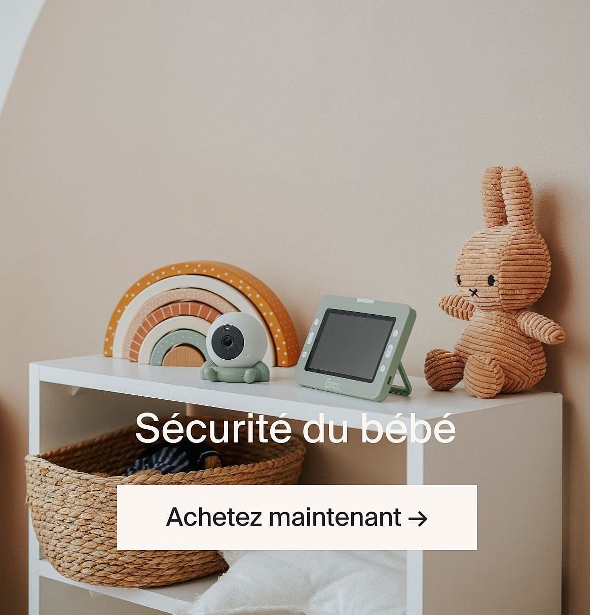 White baby monitor camera, green screen, brown bunny, and wooden rainbow on a shelf. Text: "Baby safety, Shop now."