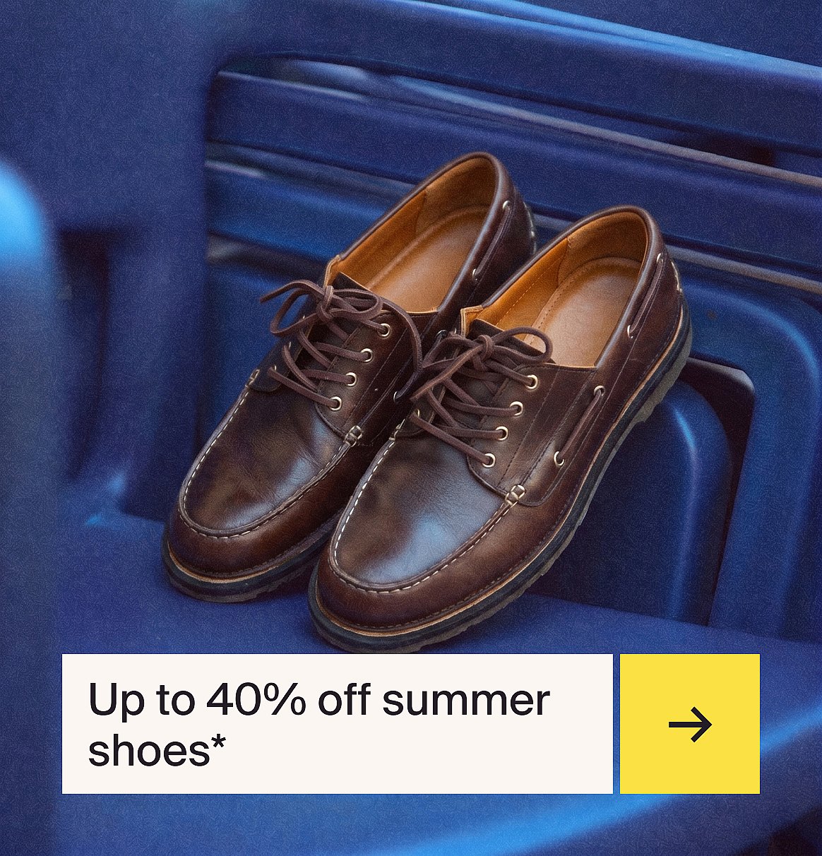 A pair of brown laced leather moccasin-style shoes with white stitching, resting on a blue ribbed surface.
