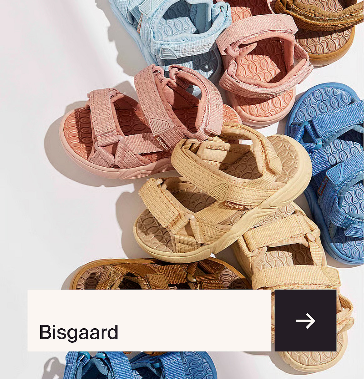 Pair of colorful sandals with pink and orange straps, white soles, and brown footbeds on a light blue surface.