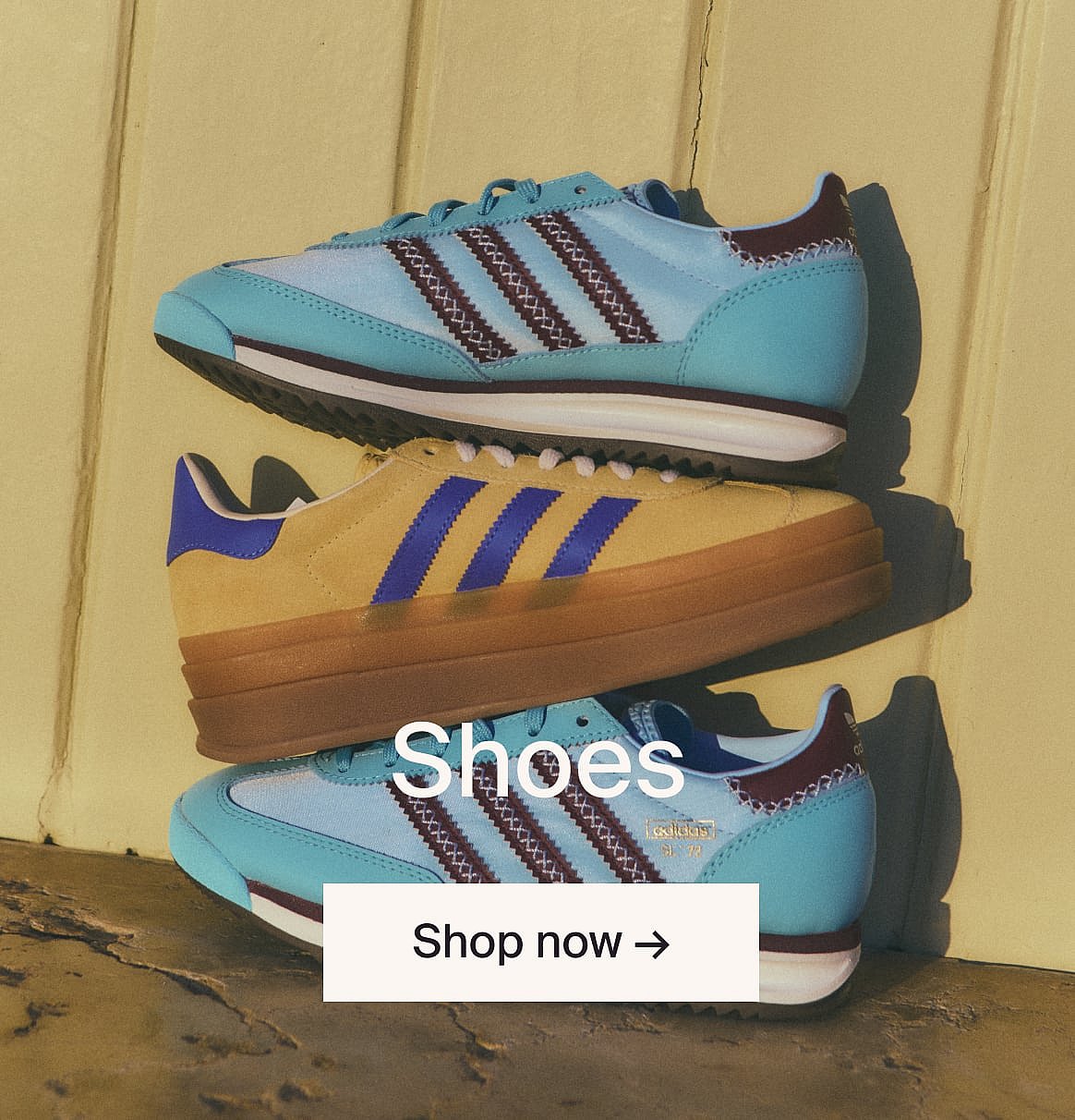 Three stacked sneakers: light blue/maroon, mustard/blue, light blue/maroon, against a yellow wall. Text: "Shoes", "Shop now".