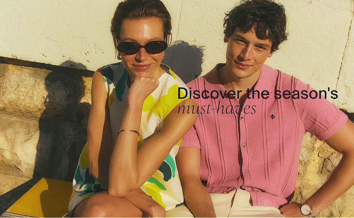 Smiling woman in sunglasses and colorful top next to man in pink polo, outdoors in sun. Text: Discover the season's