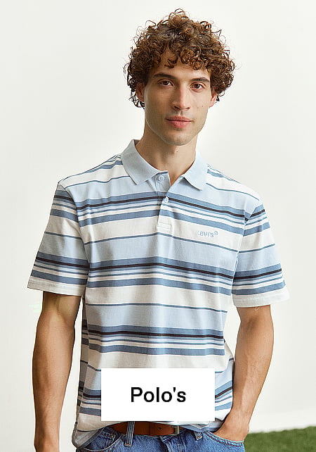 Man met krullend haar en zonnebril zit op groen gras, draagt een wit T-shirt met "Bored to Death".
Tekst: T-shirts