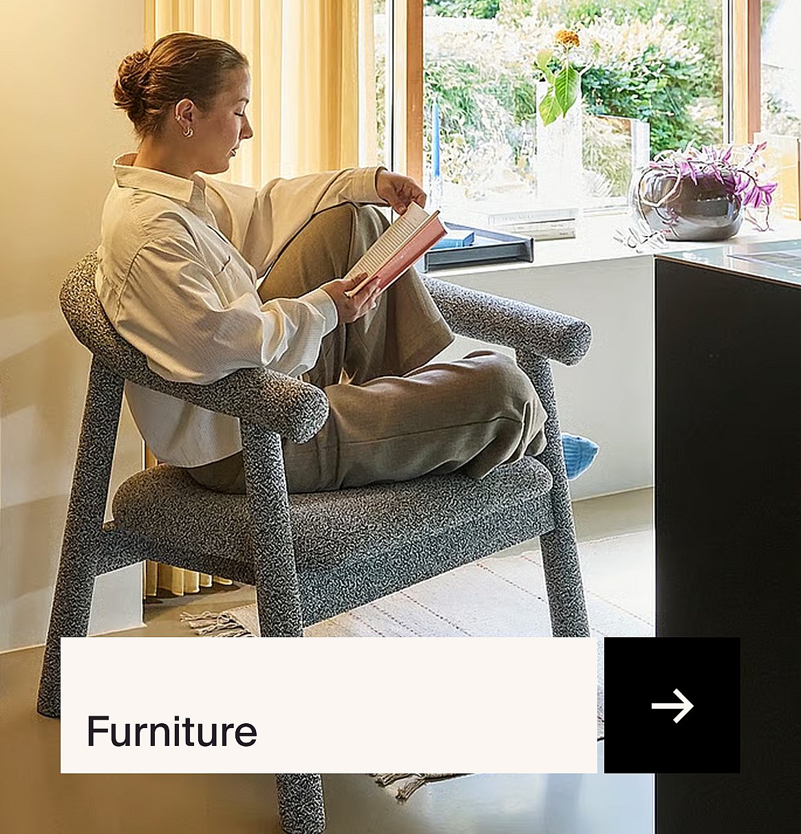 Woman in a speckled armchair reading a book by a window. Text overlay: Furniture.