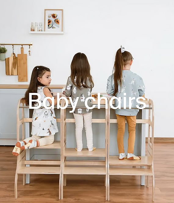 Baby in a wooden high chair, wearing a fuzzy bib, holding a wooden disc. Kitchen cabinets in background. Text: Baby chairs.