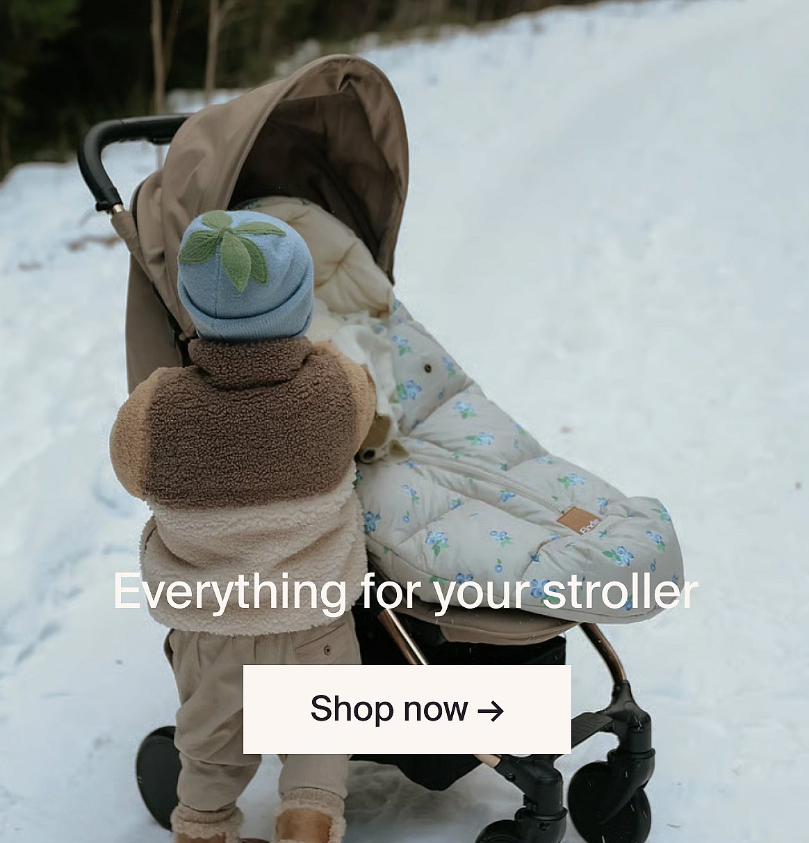 Grey stroller with leopard print seat liner and matching bag on a sidewalk. Text: Everything for your stroller. Shop now.