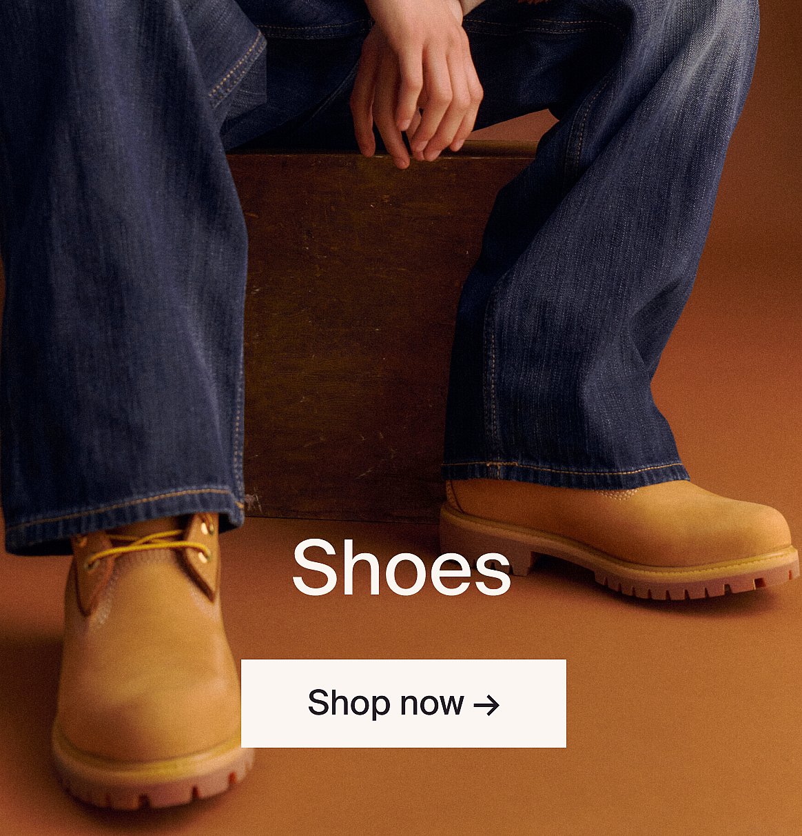 Three stacked sneakers: light blue/maroon, mustard/blue, light blue/maroon, against a yellow wall. Text: "Shoes", "Shop now".