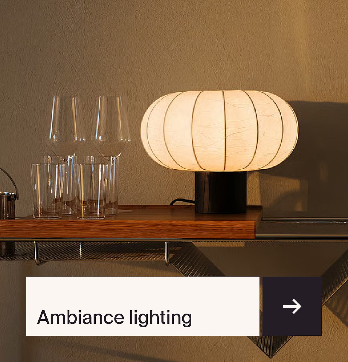 Glowing oval table lamp on a wooden shelf with glasses, against a textured wall.