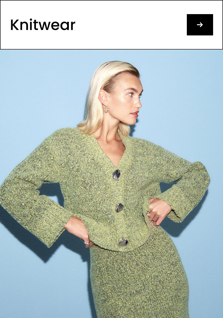 Blonde woman in a green knit cardigan and matching skirt, hands on hips, looking right, against a light blue background. Text: Knitwear